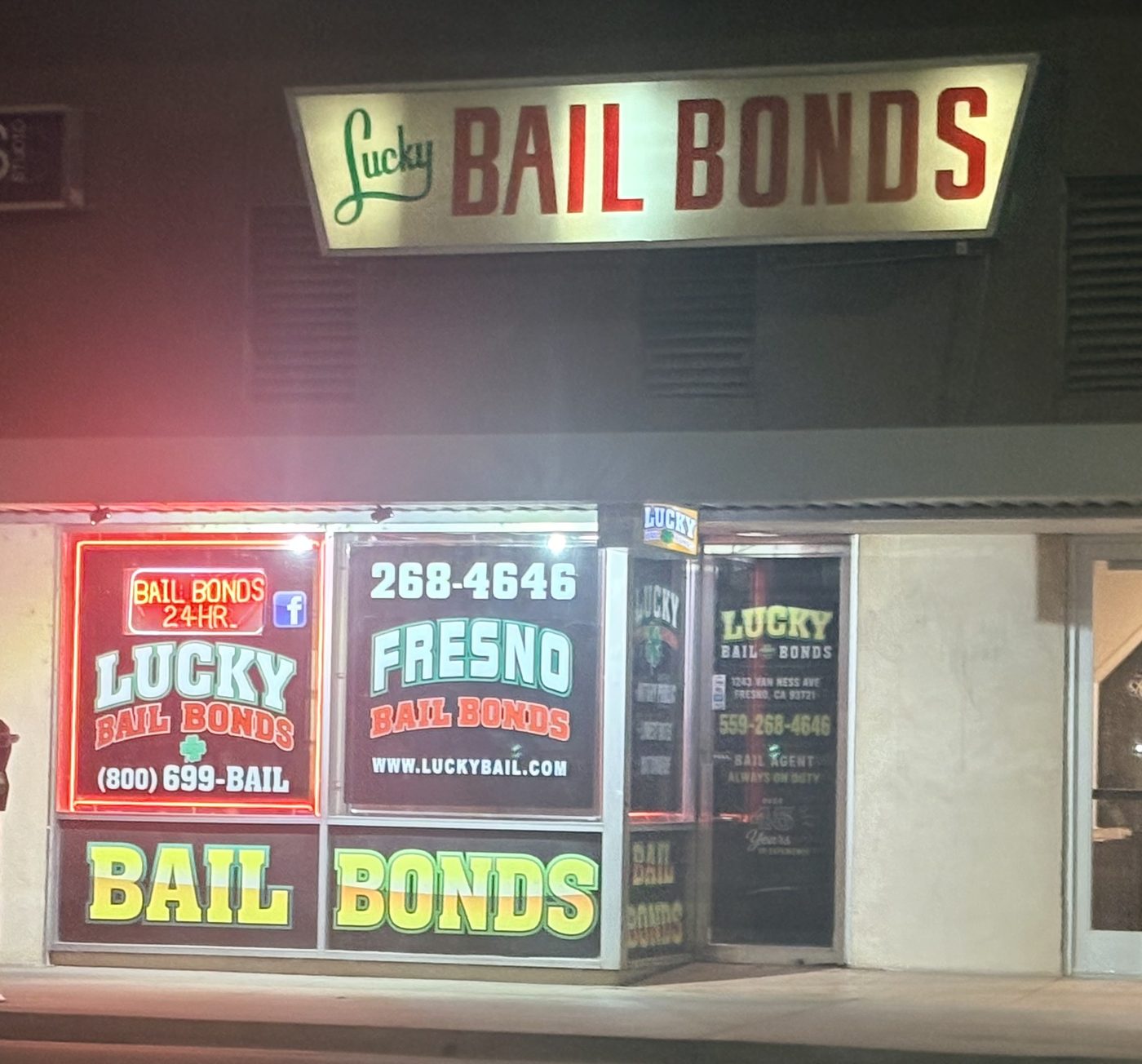 The Lucky Bail Bonds storefront on Van Ness Avenue in Fresno, lit at night
